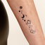 An individual wearing a daily defense vitamin patch on their forearm.