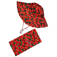 A sun hat with a red floral pattern and a matching pouch beside it, featuring bright red poppies with black details on a dark background.