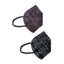 A collection of five face masks laid out on a light gray background. There are two distinct designs: three masks feature a paisley pattern with a black base and white intricate designs, while two masks are in a solid black shade.