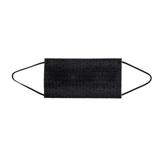A single black face mask with ear loops lying on a white surface. The mask is designed for personal protection.