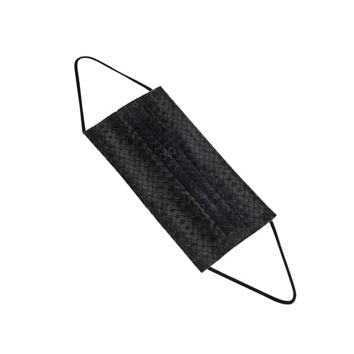 A single black face mask with ear loops lying on a white surface. The mask is designed for personal protection.