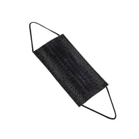 A single black face mask with ear loops lying on a white surface. The mask is designed for personal protection.