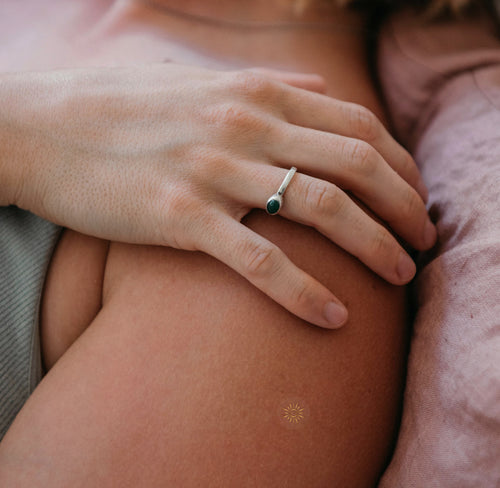 Close-up of an arm with a small adhesive patch with gold sun feature.