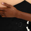 Close-up of a hand with a small vitamin patch with gold sun feature.