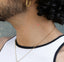 An individual wearing an 'ENERGY BOOST' vitamin patch on their neck from a side angle featuring a red heart.