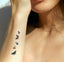 A  vitamin patch featuring five butterflies in a vertical alignment on the forearm. 