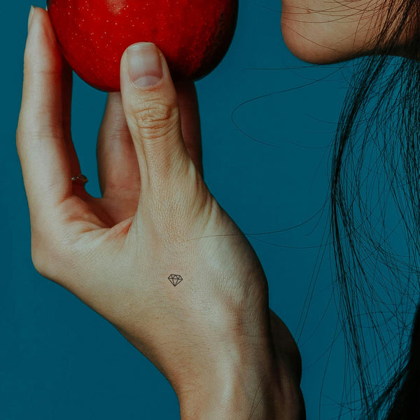 Someone eating an apple while wearing a ‘CALL OF BEAUTY’ vitamin patch.