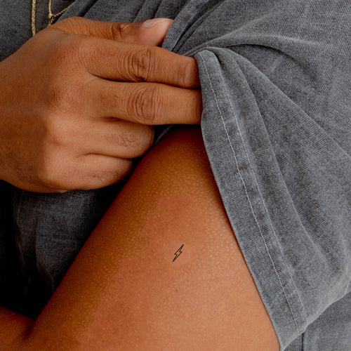 Close up of an individual with an ‘ENERGY BOOST’ vitamin patch stuck on their arm.