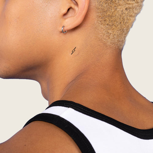 An individual with an ‘ENERGY BOOST’ vitamin patch stuck on their neck.