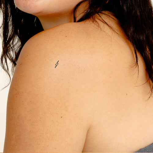 An individual with an ‘ENERGY BOOST’ vitamin patch visible on the shoulder.