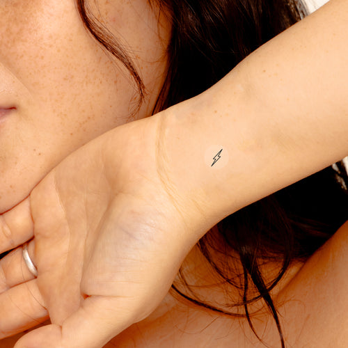 An individual with an ‘ENERGY BOOST’ vitamin patch stuck on their inner wrist.
