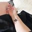 A person’s arm with a vitamin patch featuring a stylized sun with rays extending outward and a crescent moon within the sun’s circle.