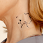 An individual wearing a daily defense vitamin patch on their neck.