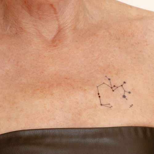 An individual wearing a daily defense vitamin patch on their collarbone.