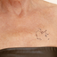 An individual wearing a daily defense vitamin patch on their collarbone.