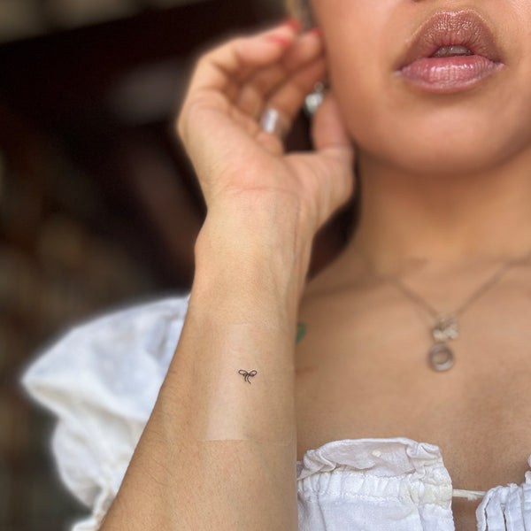 An individual wearing a small black ‘daily defense’ patch on their inner arm.