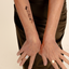 Close-up of a forearm with a black vitamin patch of a palm tree, airplane post card feature.