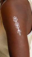 An individual wearing a white “DAILY DEFENSE PATCH” on their arm.